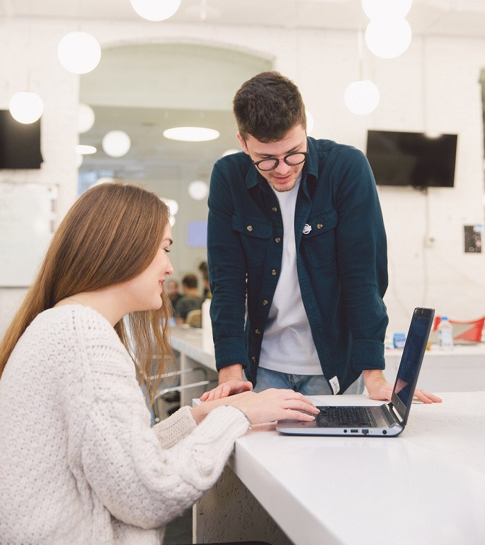 two colleagues working with a laptop