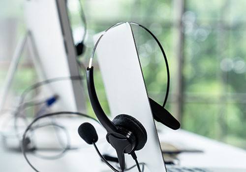 Headset hanging on a computer screen