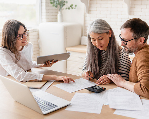 People discussing paperwork with a tablet at home
