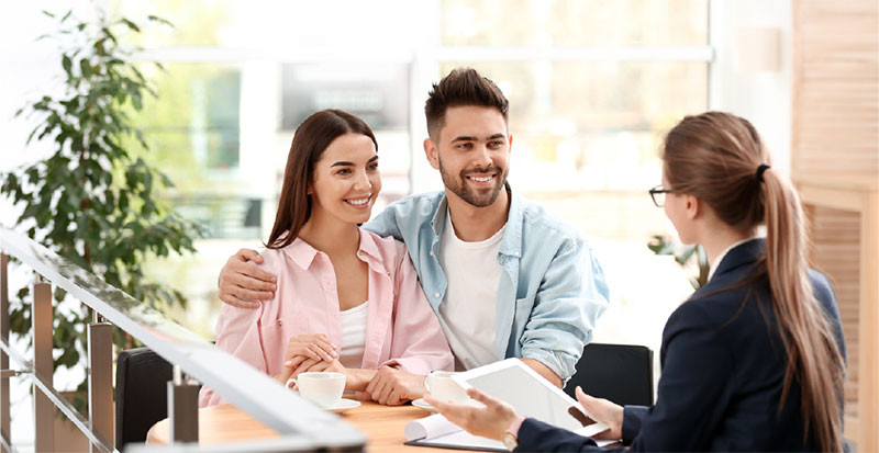 A pregnant woman sits comfortably for insurance procedures.