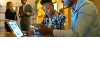 two men looking at tablet