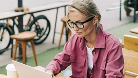 A woman sitting and working on a laptop