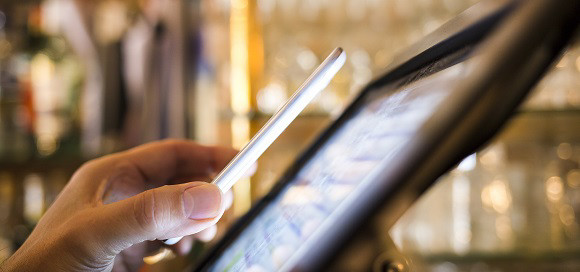 Man paying with NFC technology on mobile phone, in restaurant, bar, cafe; Shutterstock ID 163505681; purchase_order: 868950; job: GBC - GLT; client: Europe; other: 