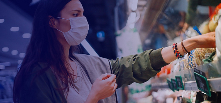 Masked woman shopping