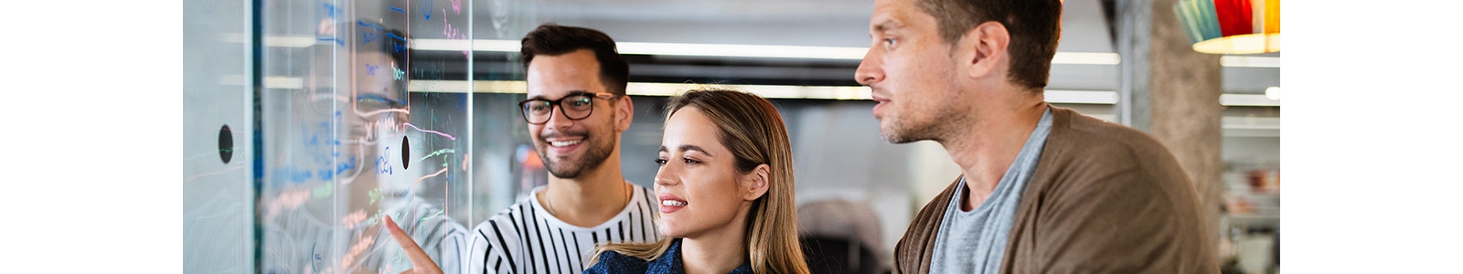 A woman touching digital board with his friends