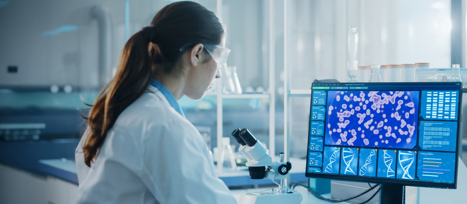 A lab technician looking into a computer screen