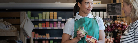 Cashier and customer smiling at the billing counter