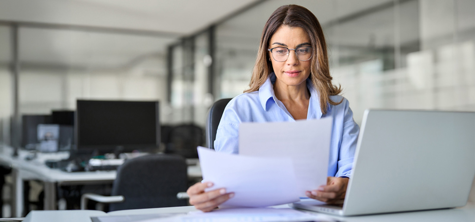 A woman checking compliance documents at work