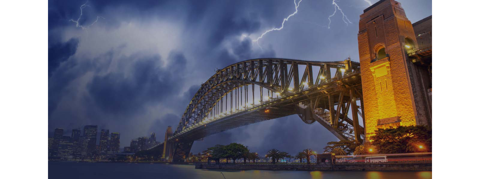 A bridge with lights and sky looks too dark with lightening.