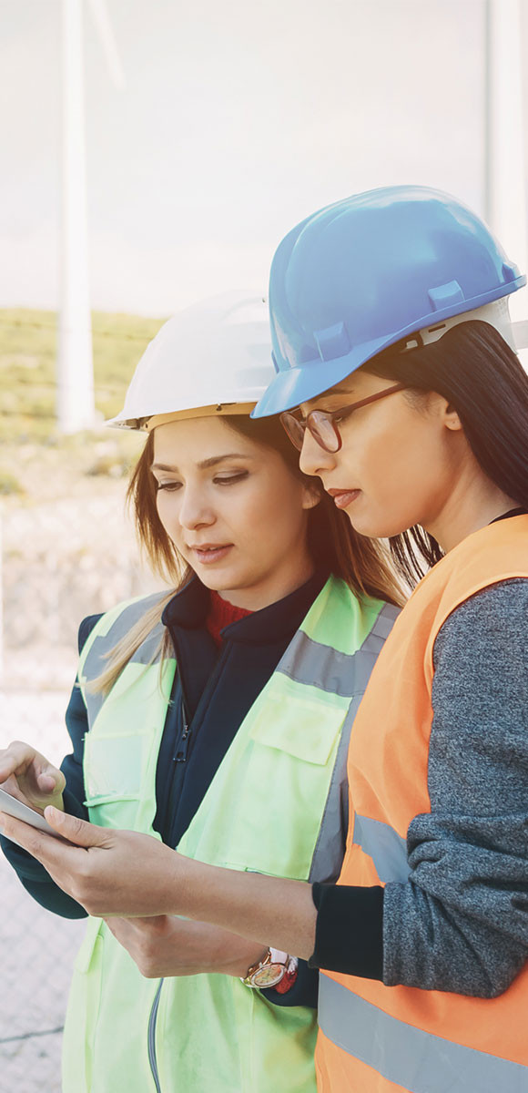 Two female coworker viewing tablet device