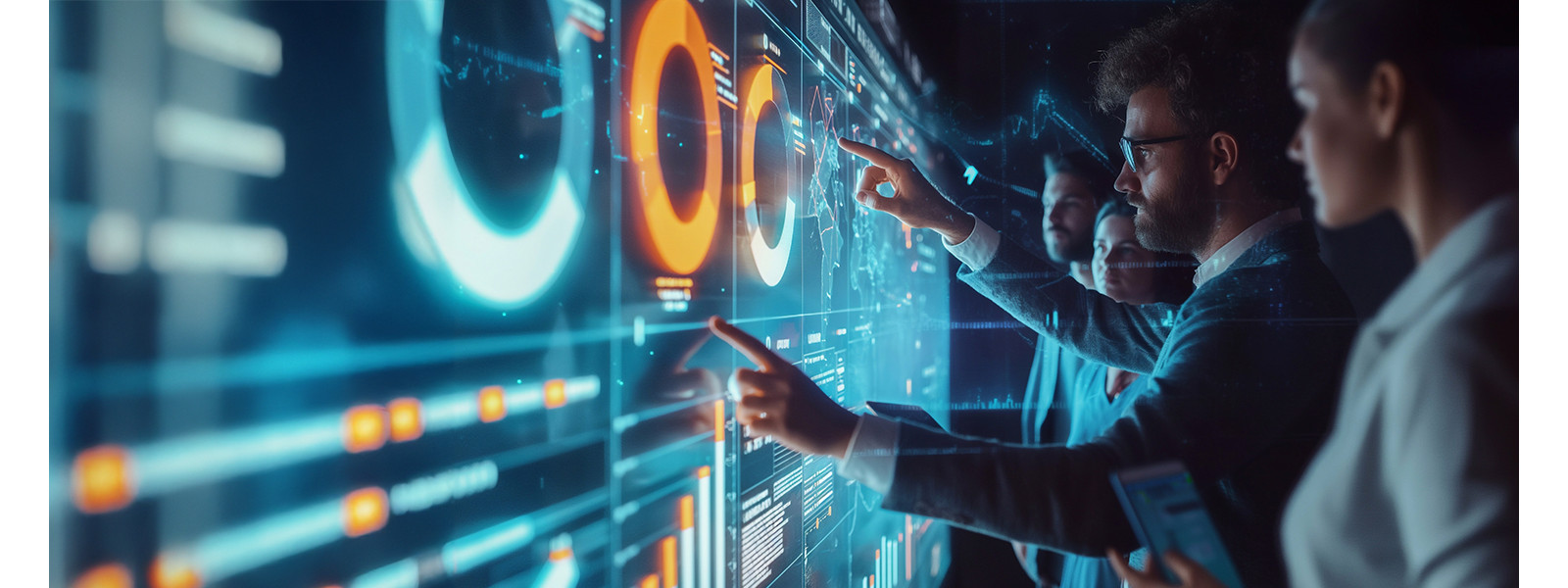 A group of people standing and studying a large digital display of data