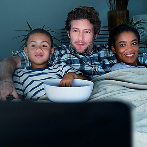 father and sons watching tv