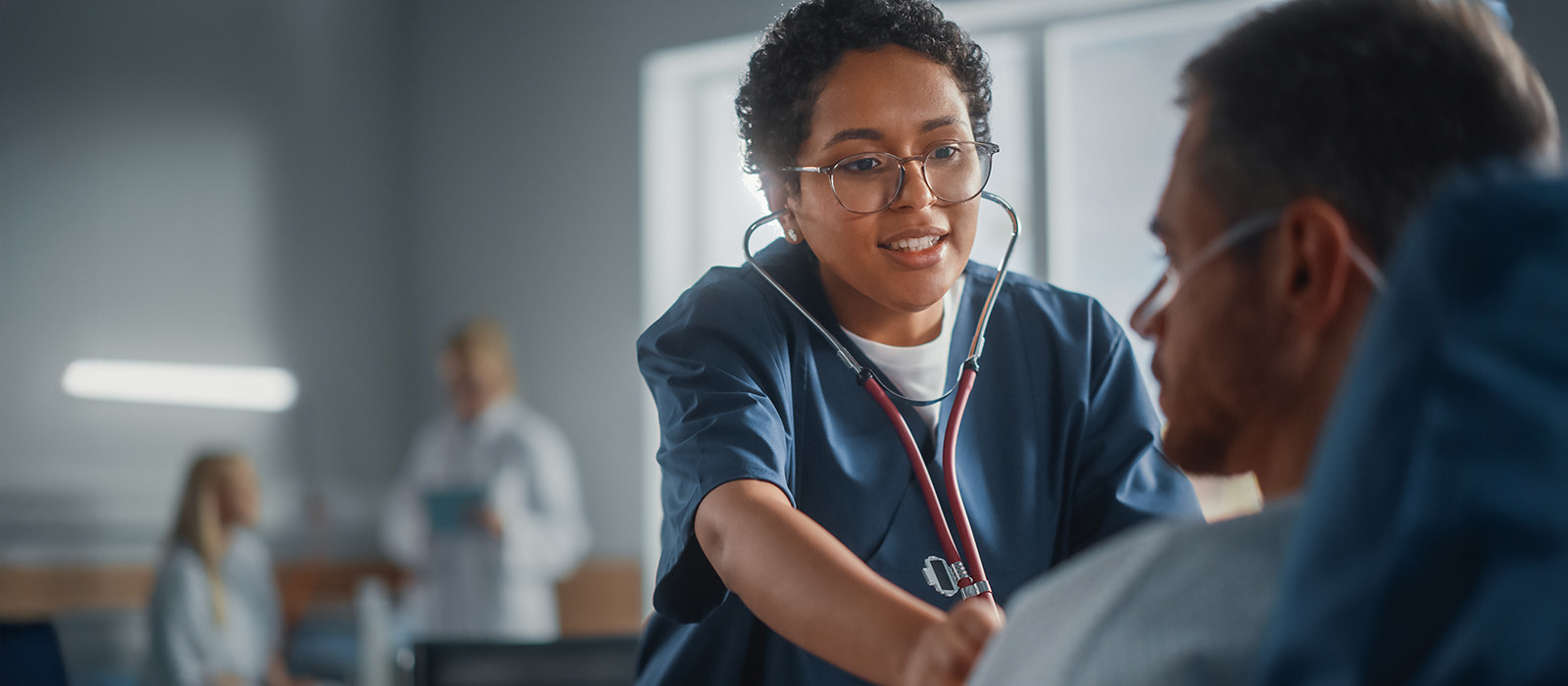 A doctor examining a patient using a stethoscope.