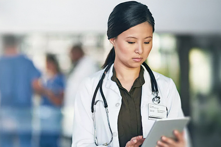 Doctor working on tab