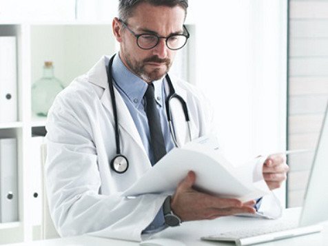 doctor looking through papers