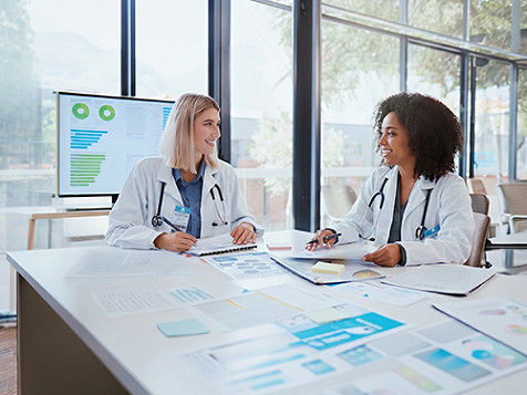 A life sciences healthcare professional explaining something on a live video call on a laptop