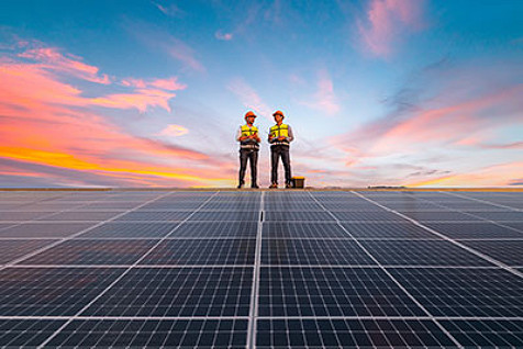 men standing on solar panel