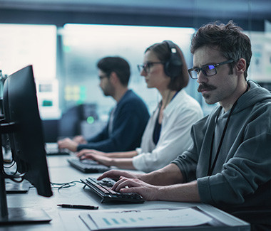 Vue de profil d'une équipe d'ingénieurs en informatique.