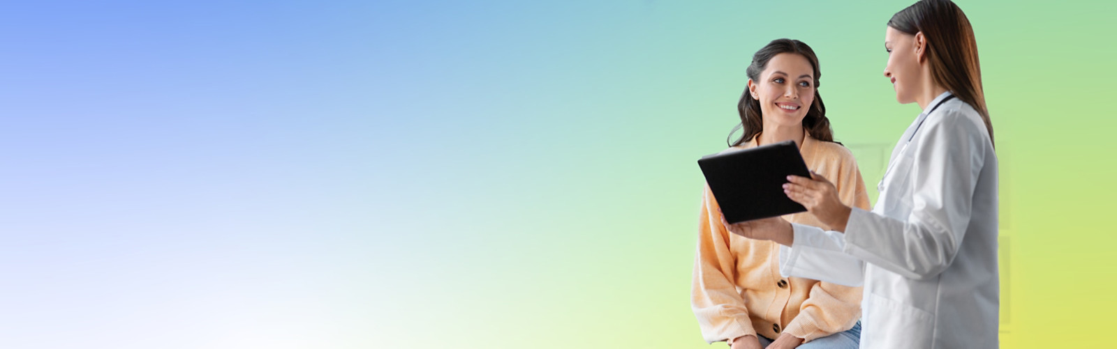 A medical professional holing a tablet, talking to a woman