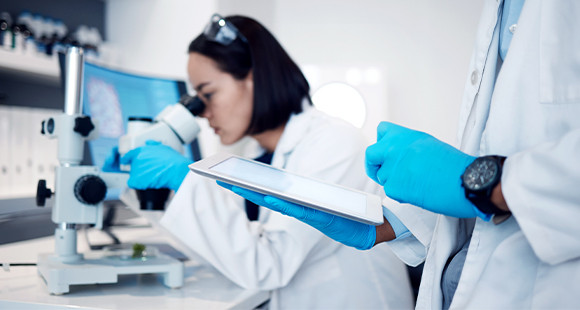 Female doctor looking through a microscope