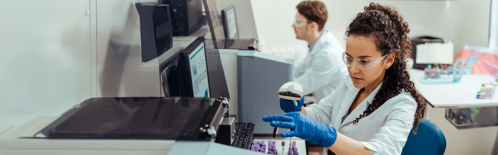 A female lab technician working inside a lab
