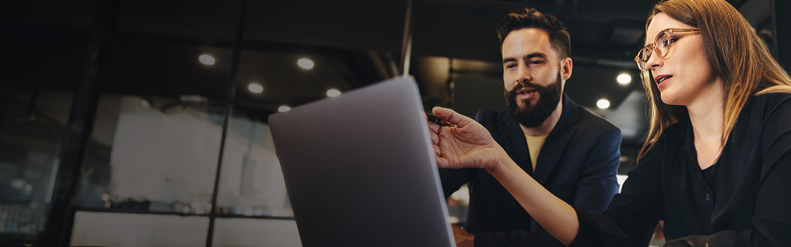 man and women looking laptop