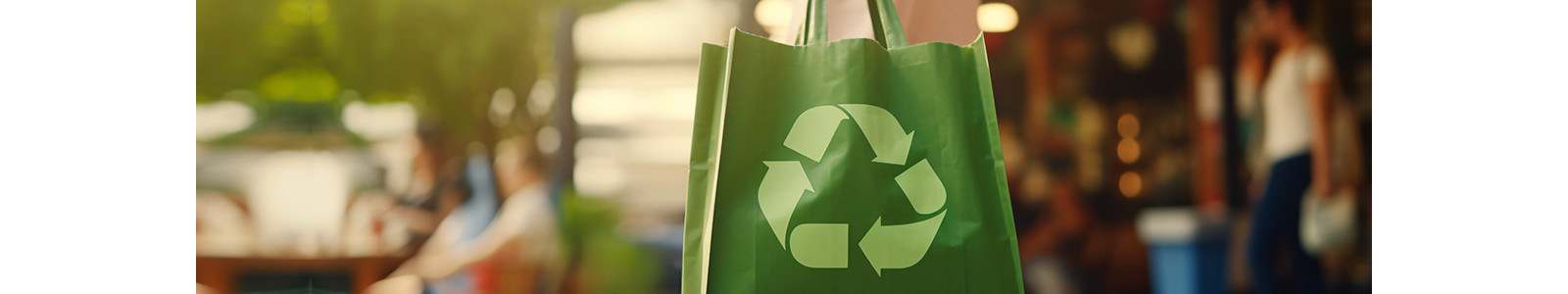 A green color paper bag with recycle symbol on it.