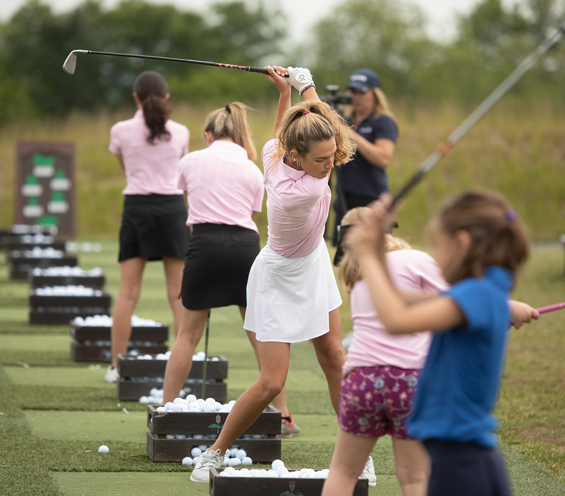 women and children playing golf