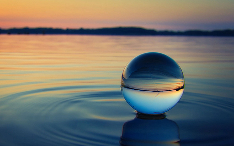 A glass ball on a water surface