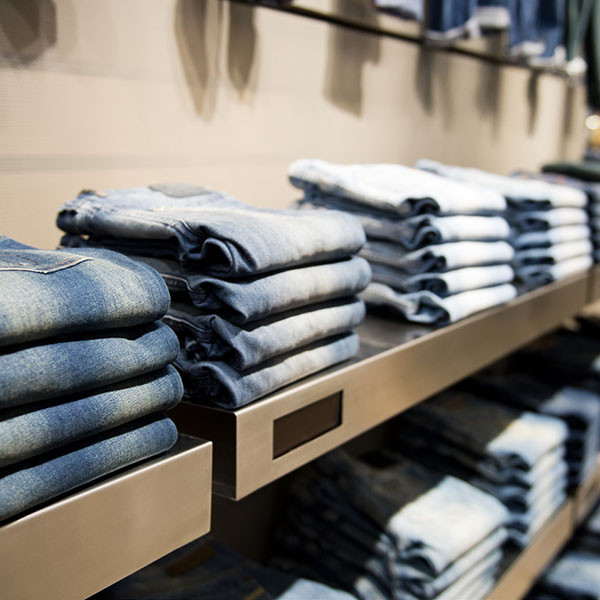 Racks with stacks of folded denims, like in a store