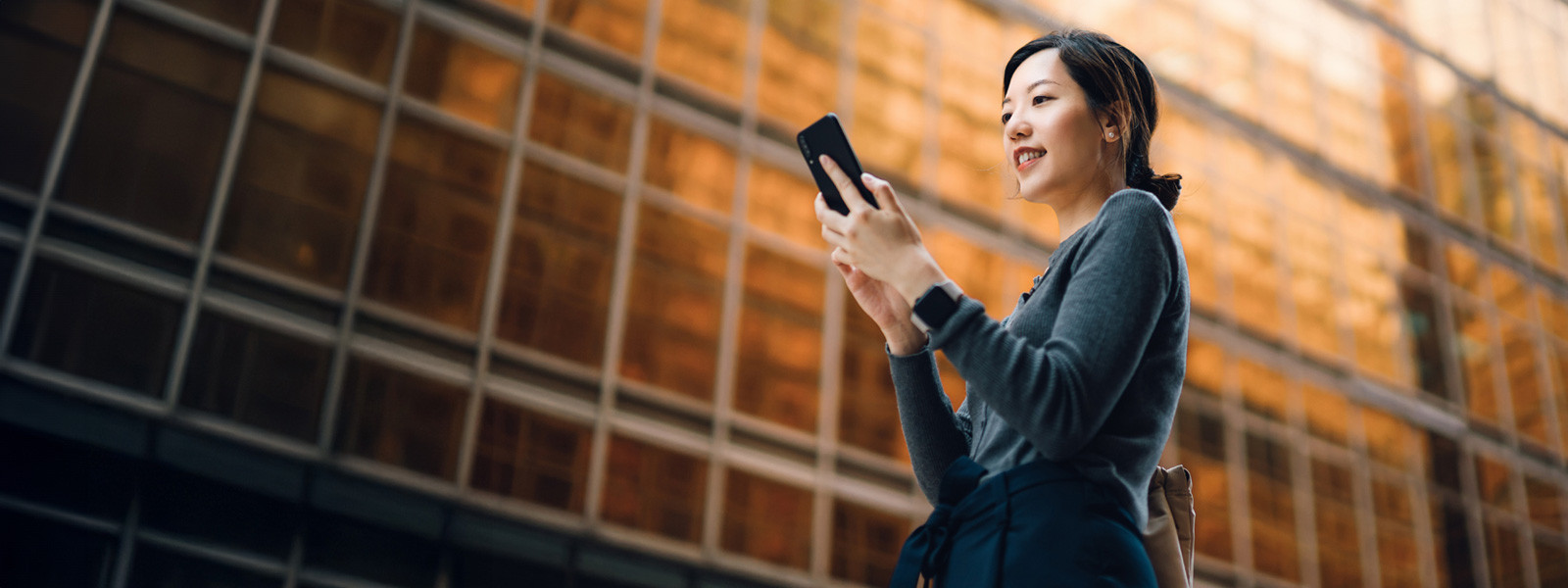 A woman using laptop and also mobile