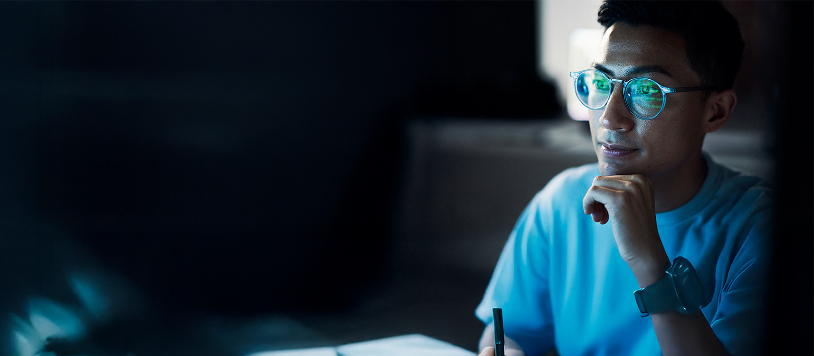 Abstract background featuring a man with glasses gazes directly at the camera, showcasing a friendly expression
