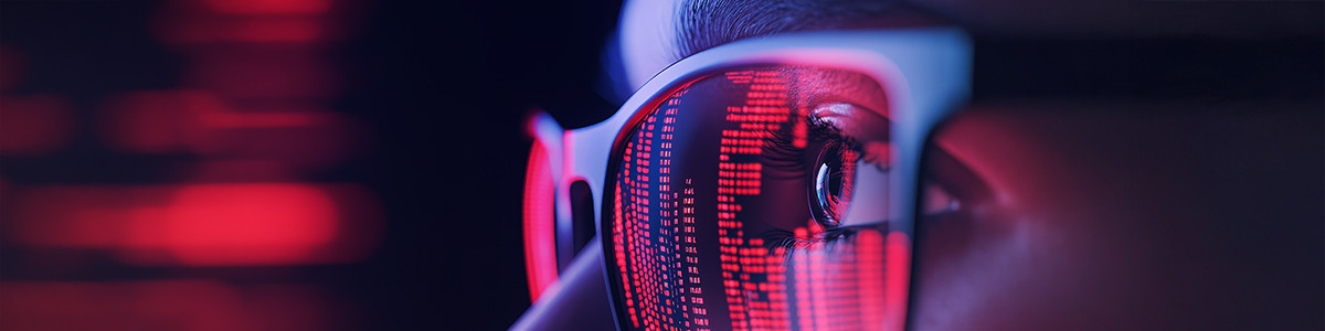 Close up view of a woman in her eyeglasses with red reflective lights surrounding her.