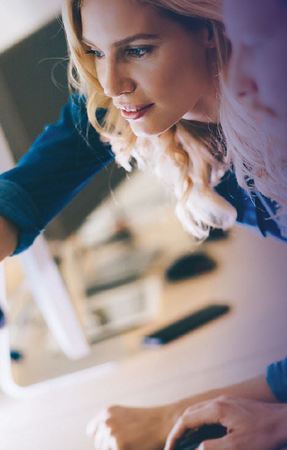 women pointing at workstation monitor