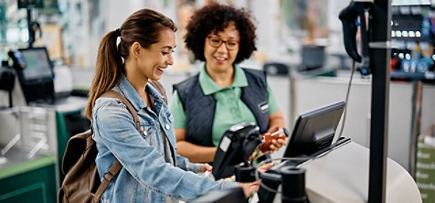 Two smiling women working on a computer