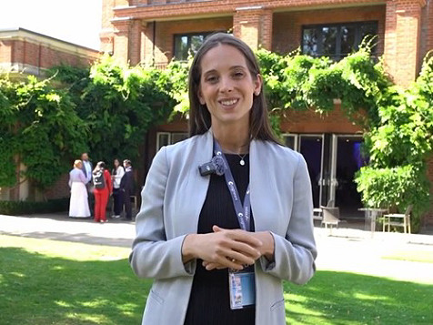 A woman official standing outside a building