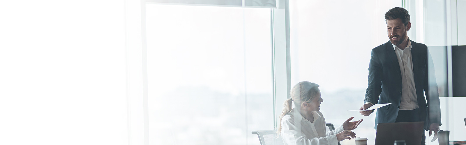 People involved in a serious discussion in a corporate workplace