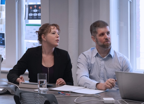 Two people sitting at a desk 