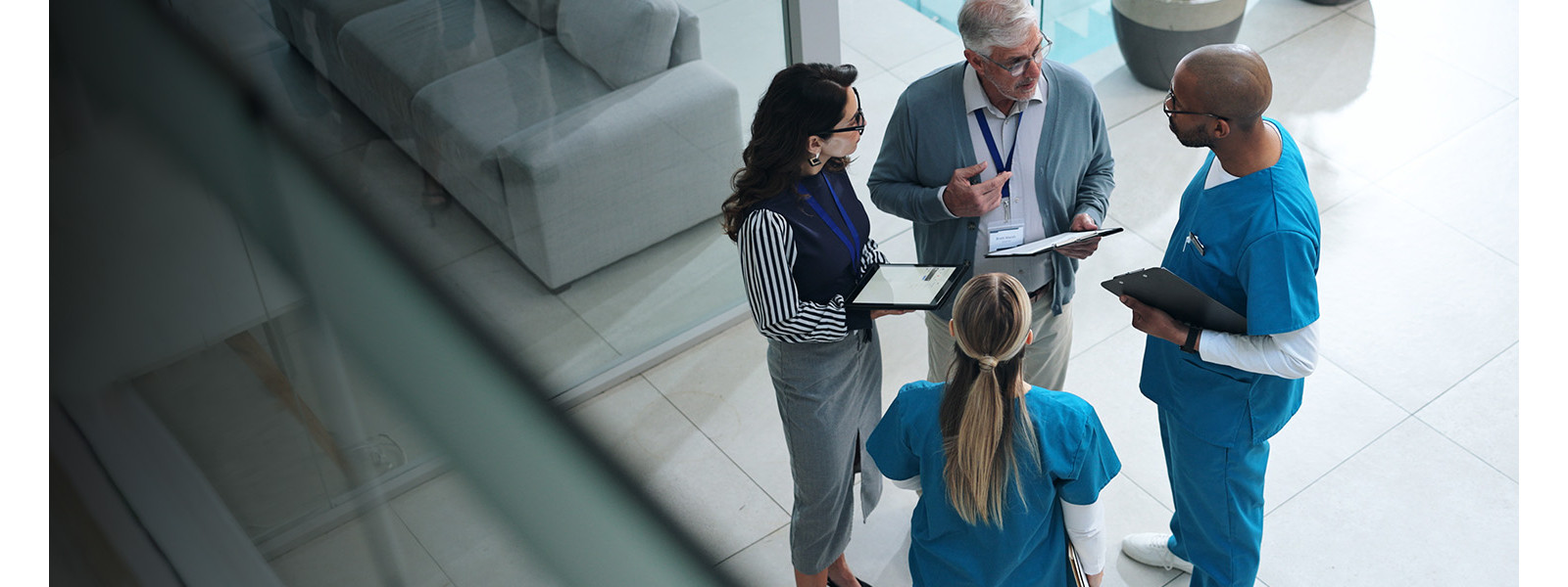 Four professionals standing in a circle and discussing