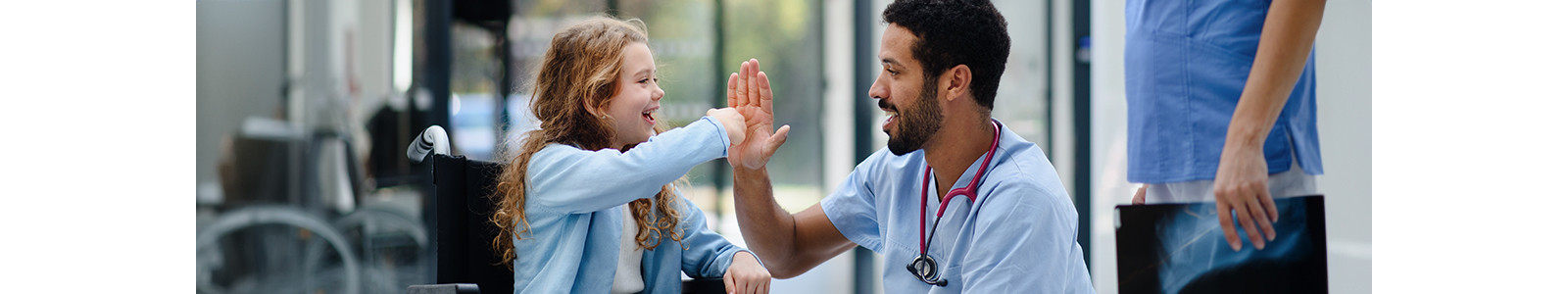 A child in wheelchair giving Hi-Fi to doctor