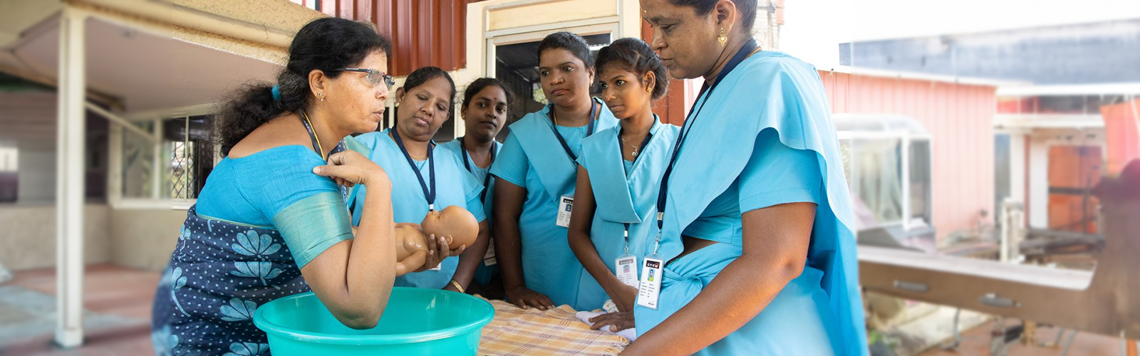 Nurse holding a plastic baby