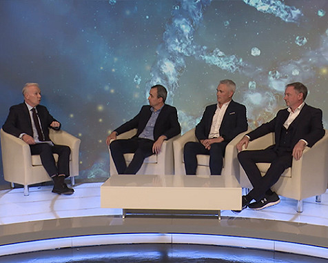 four men sitting, in discussion