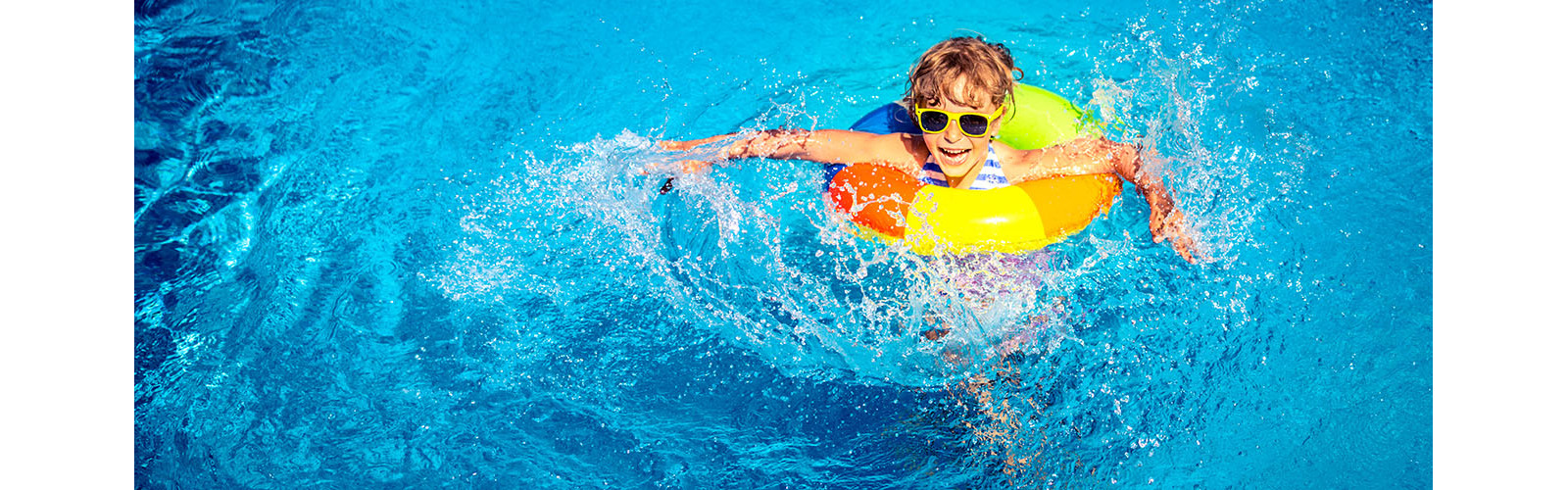 Happy child playing in swimming pool. Summer vacation concept. Top view portrait