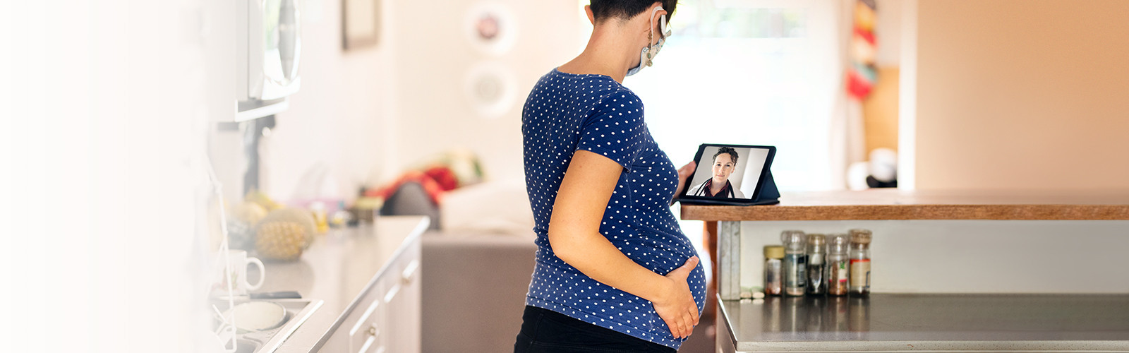 gravid kvinne konsulterer lege på et nettbrett