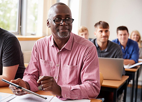 an old man sitting in the classroom