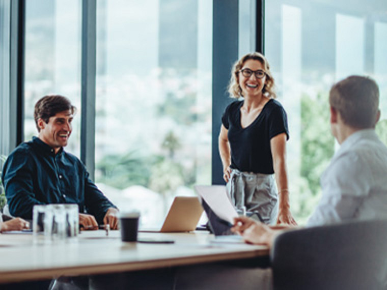 A group meeting at work with smiling colleagues