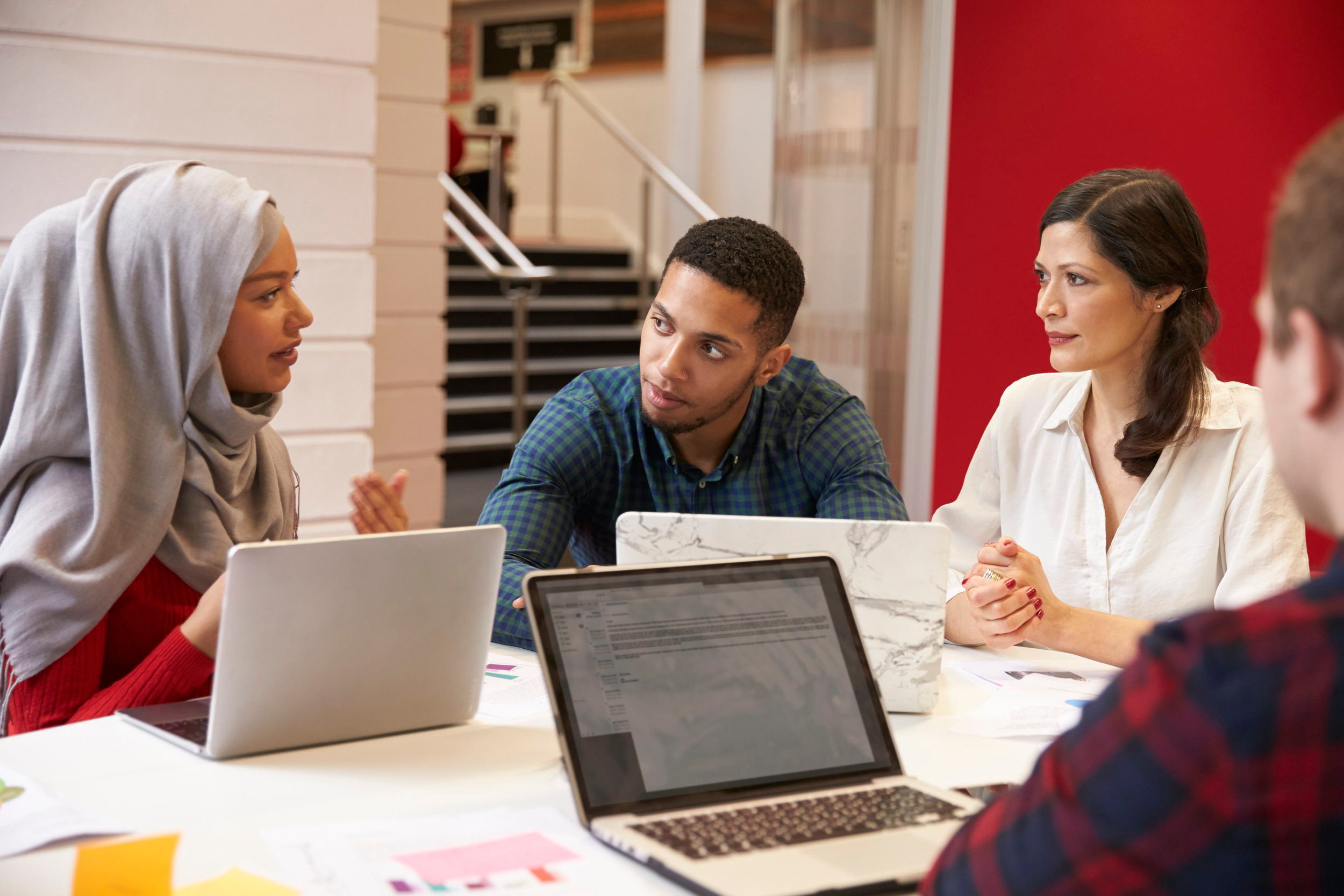 Group Of Students Meeting For Tutorial With Teacher