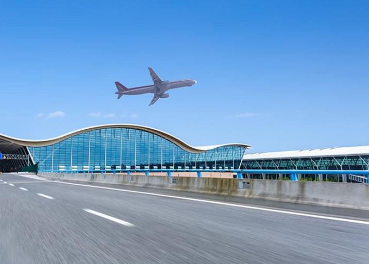 an airplane flying over an airport