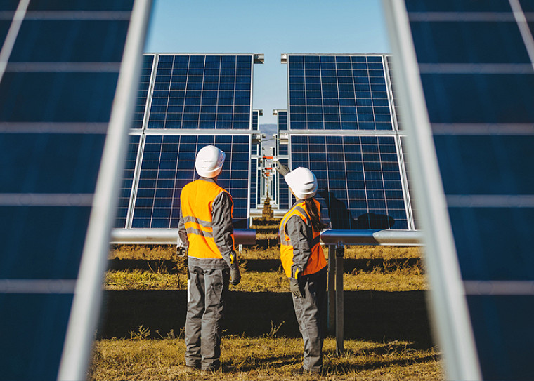 two solar panel engineers looking at installations