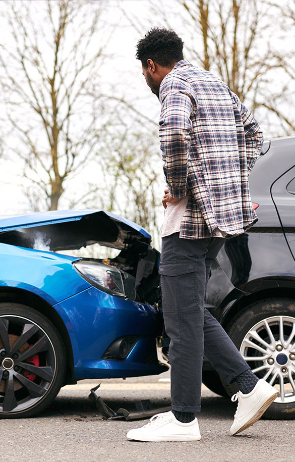 Man looking at blue car crash in rear of gray car